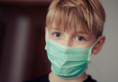child wearing surgical mask covid 19