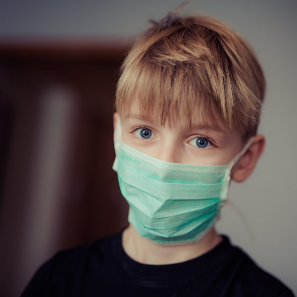 child wearing surgical mask covid 19